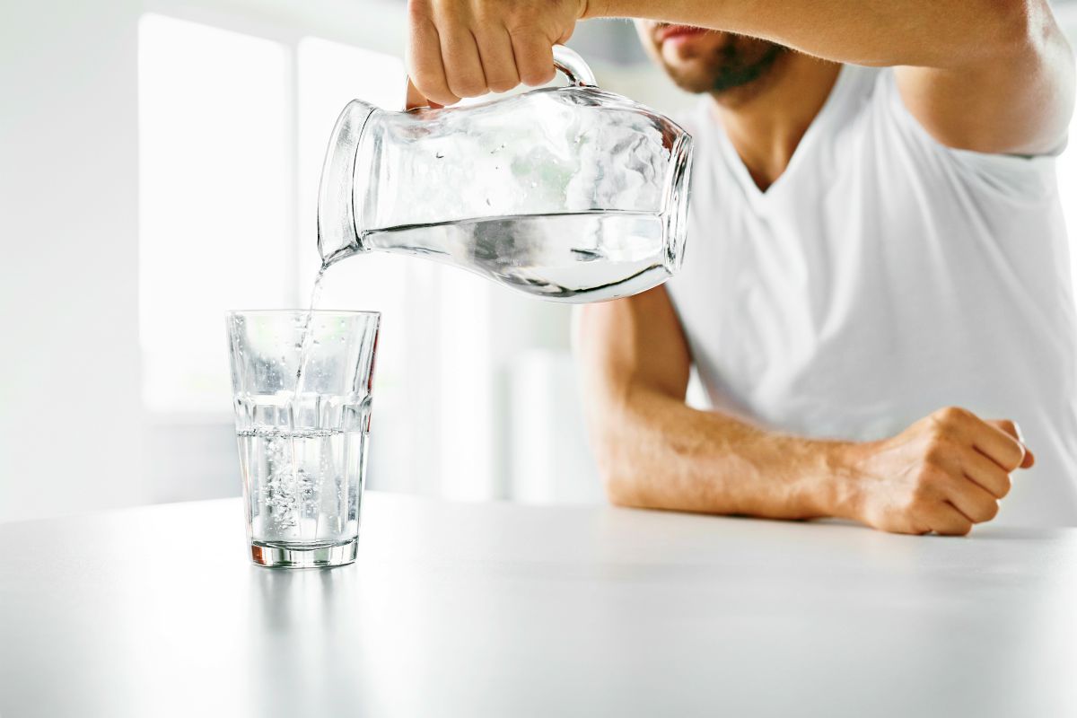 man pouring water | Can Drinking Water Improve Your Gut Health? | leaky gut syndrome